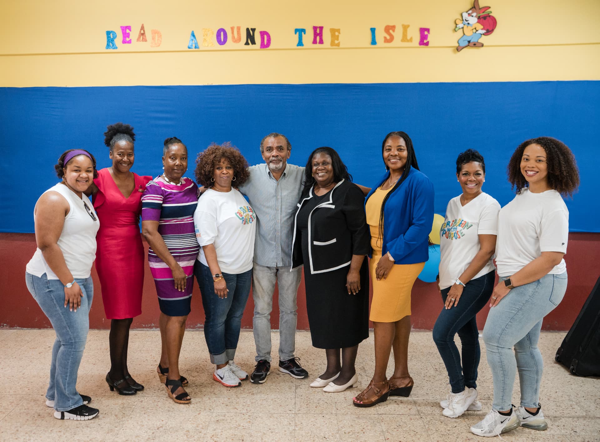 Educators and partners gathered beneath a Read Around the Isle banner